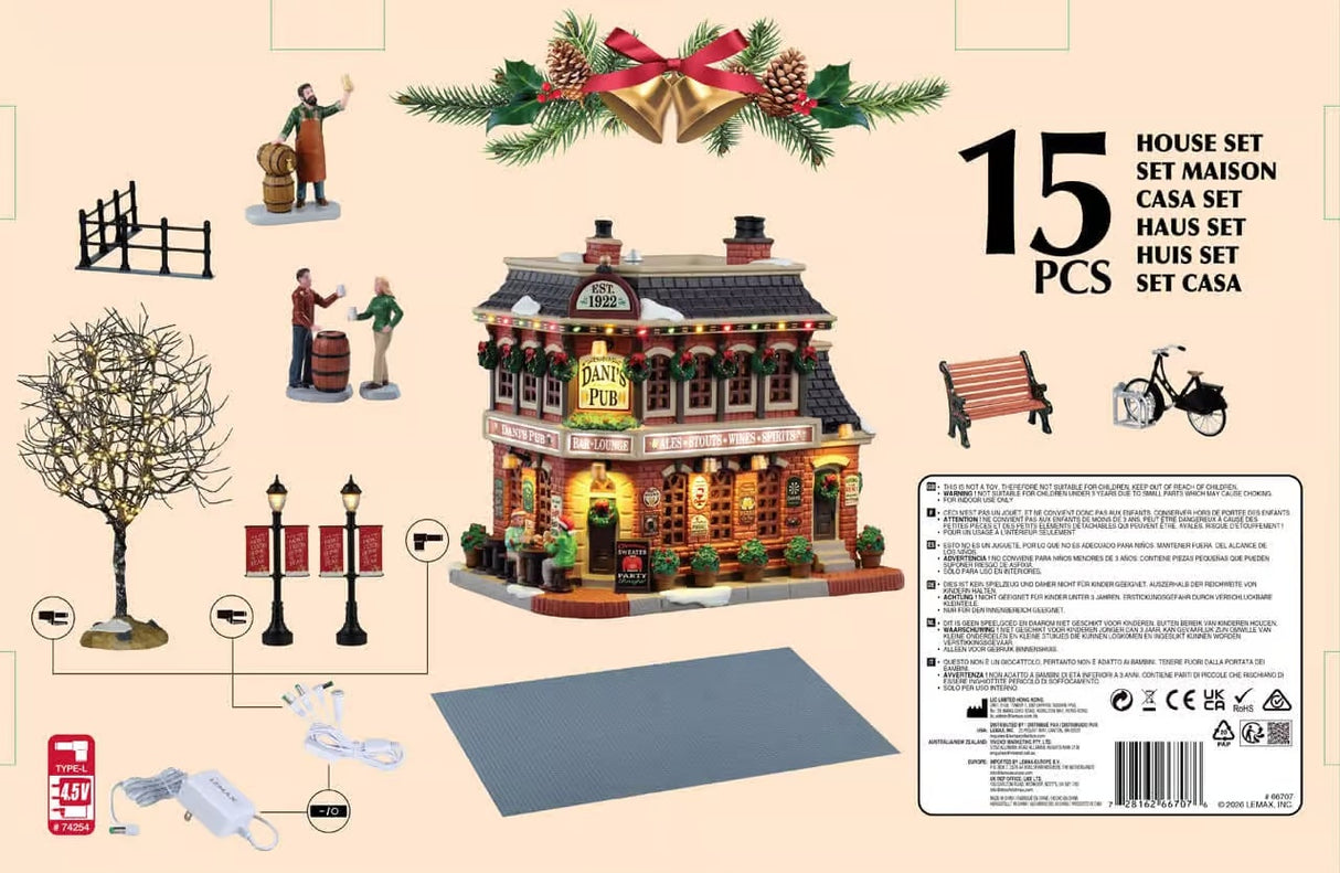 This image shows all fifteen pieces of this Lemax house set. The pieces include a fence, a man with some wooden kegs, two people talking over a wooden keg, a lighted tree, two lampposts, Dani's Pub, a stone landscape, a bench and bicycle. 