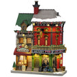 This image shows what this Lemax building looks like on a white background. It was designed to look like a tall building consisting of two business. The left is called the Rustic Bakery and inside the windows, you can see the different menus. The right is called King's Corner Pub. There's snow on the roof and on the sidewalk. 
