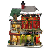 This image shows what this Lemax building looks like on a white background. It was designed to look like a tall building consisting of two business. The left is called the Rustic Bakery and inside the windows, you can see the different menus. The right is called King's Corner Pub. There's snow on the roof and on the sidewalk. 