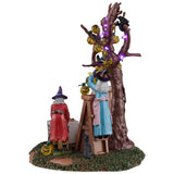 This is another angle of this piece. You can see a witch standing on a ladder and another witch digging through a box.