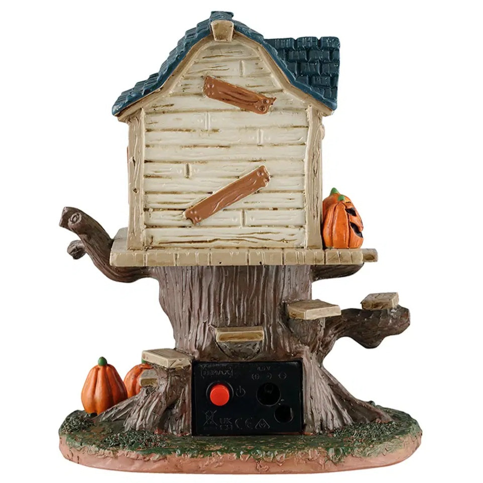This is the other side of the house. There are some wooden boards nailed to the house. You can also see the black power box used to plug in and make the house light up.