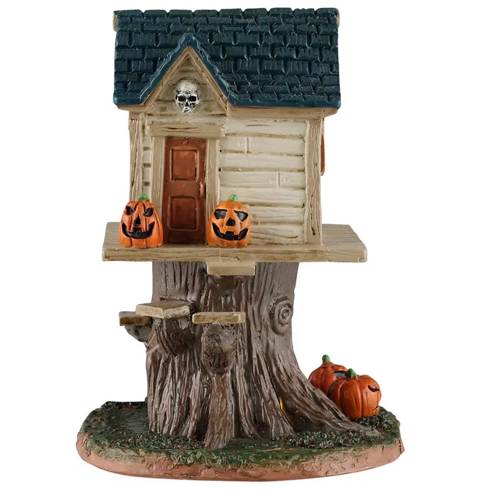This image shows what the back of the tree house looks like. It has a dark royal blue roof, a skull above the back door and some wooden steps.