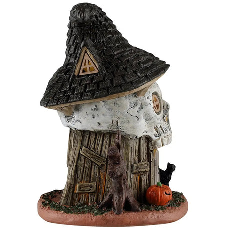 This is the side of this table accent. There's a window in the roof/hat. You can see a bare tree next to the door, along with a jack-o-lantern.