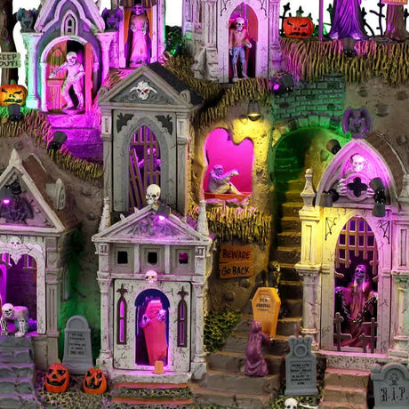 This is a zoomed in version of the first photo to focus on more of the details. There are stone stairs leading into a crypt. There are signs that read "BEWARE," "KEEP OUT" and "GO BACK." The mausoleums have skull and bat decorations.