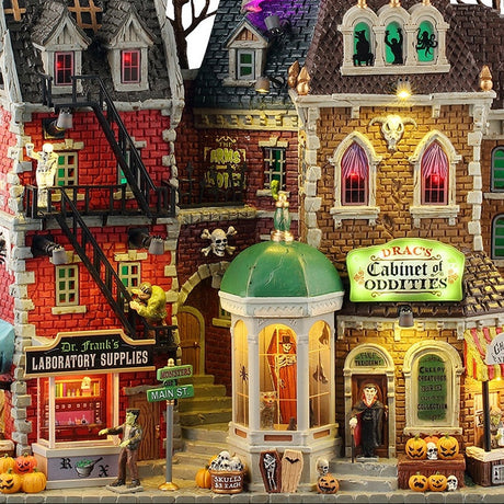 This is a zoomed in version of the main image. You can see the names of the different stores: Dr. Frank's Laboratory Supplies, Drac's Cabinet of Oddities and Ghouly News.