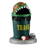 This trash can has a top that was designed to look like an orange bug with sharp teeth and red eyes. There's a red cup discarded on the ground next to the can, along with a skull.
