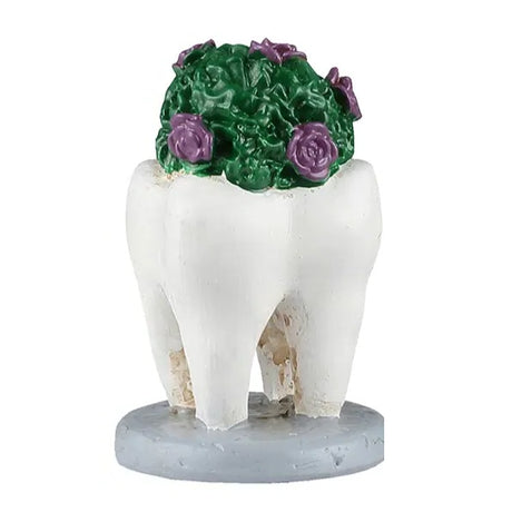 This image shows a green bush with purple flowers growing inside a tooth.