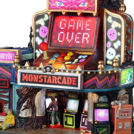 This is an up close view of the lighted building. There's someone inside playing an arcade game. There's a monster sitting on the sidewalk. On the outside of the building, there are some games and an orange-ish pink colored token machine. On top of the token machine, there's a skeleton laying down.