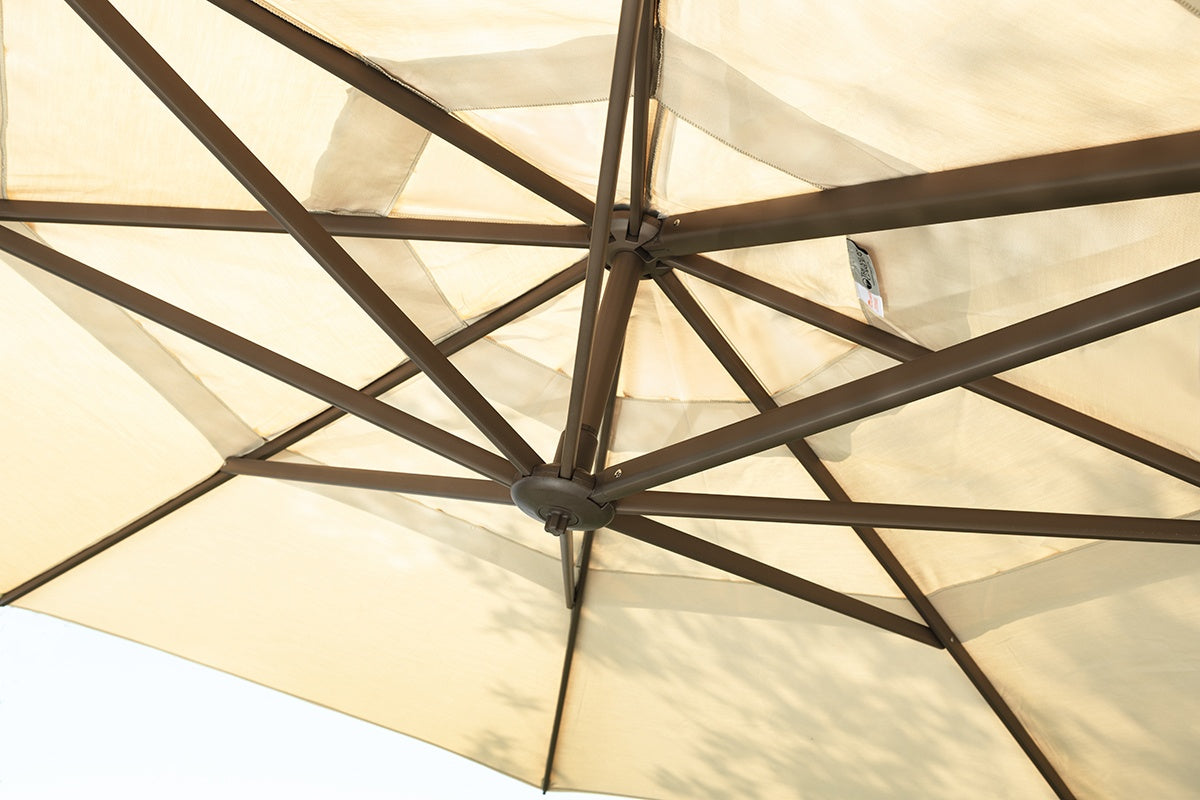 This is a lifestyle image showing what this champagne cantilever umbrella looks like from underneath.
