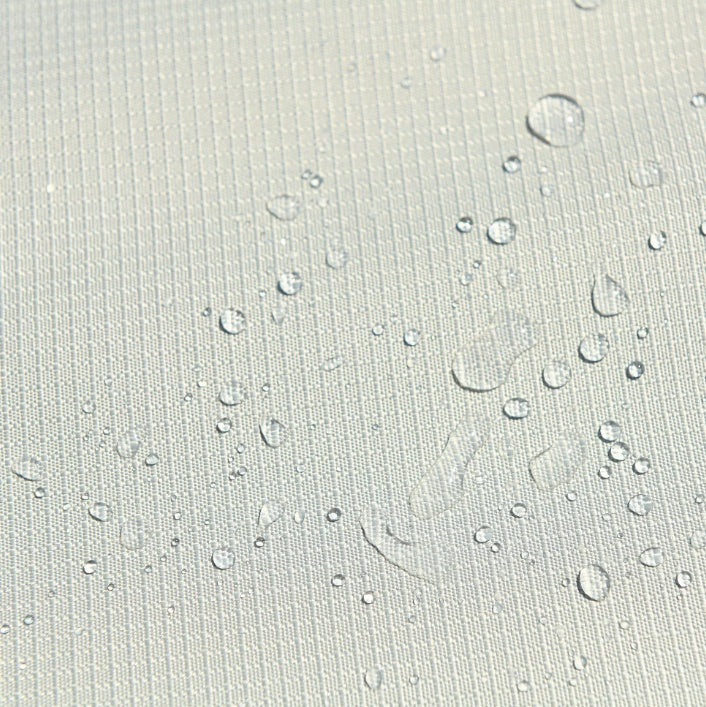 This is an up close image of the fabric with some water droplets on it to show that it's waterproof.
