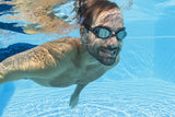 This is a lifestyle image showing a man swimming underwater wearing the black goggles.
