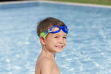 This is a lifestyle image showing a young boy with the blue goggles on his forehead near a pool.