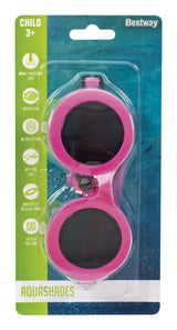 This image shows the packaging that the neon pink goggles come in. It reads "Child 3+. Bestway. Impact-resistant lens. Tinted lens. UV-protection. Anti-fog lens. Comfort-fit silicon strap. Latex and PVC free. AquaShades."