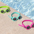 This is a lifestyle image showing all three of the color options for these goggles on the edge of a pool.
