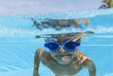 This is a lifestyle image shows a young boy swimming underwater wearing the shark themed goggles.