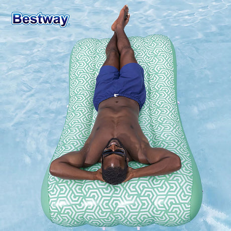This is a lifestyle image showing a man resting on the float in a pool. The sunshade is not attached.