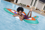 This is a lifestyle image showing a woman laying on the pool float in the middle of a pool.