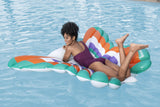 This is a lifestyle image showing a woman laying on her stomach on the pool float in a pool.
