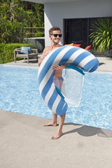 This is a lifestyle image showing a man holding the pool chair while standing next to a pool.