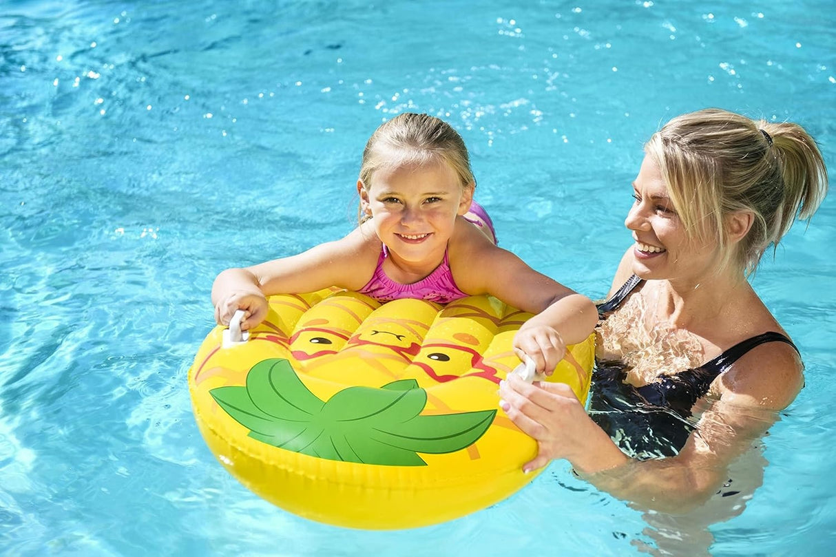 This is a lifestyle image showing a little girl holding onto the handles of this pool inflatable while her mom leads her through the water.