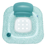 This is an aerial view of the inflatable pool chair on a white background. The outer rim of the chair has a teal and white mosaic-like design, a flip-able teal headrest, a teal cupholder and a white bottom with holes in it so you can stay cool in the water.