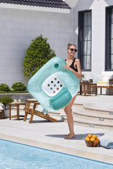 This is a lifestyle image showing a woman bringing the inflatable pool chair into the pool.