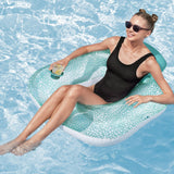 This is a lifestyle image showing a woman lounging in this inflatable pool chair. There's a cup of lemonade in the cupholder.