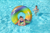 This is a lifestyle image showing a young girl inside the inner tube in the water.
