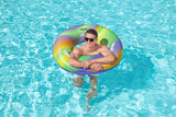 This is a lifestyle image showing a man inside the inner tube in a pool.