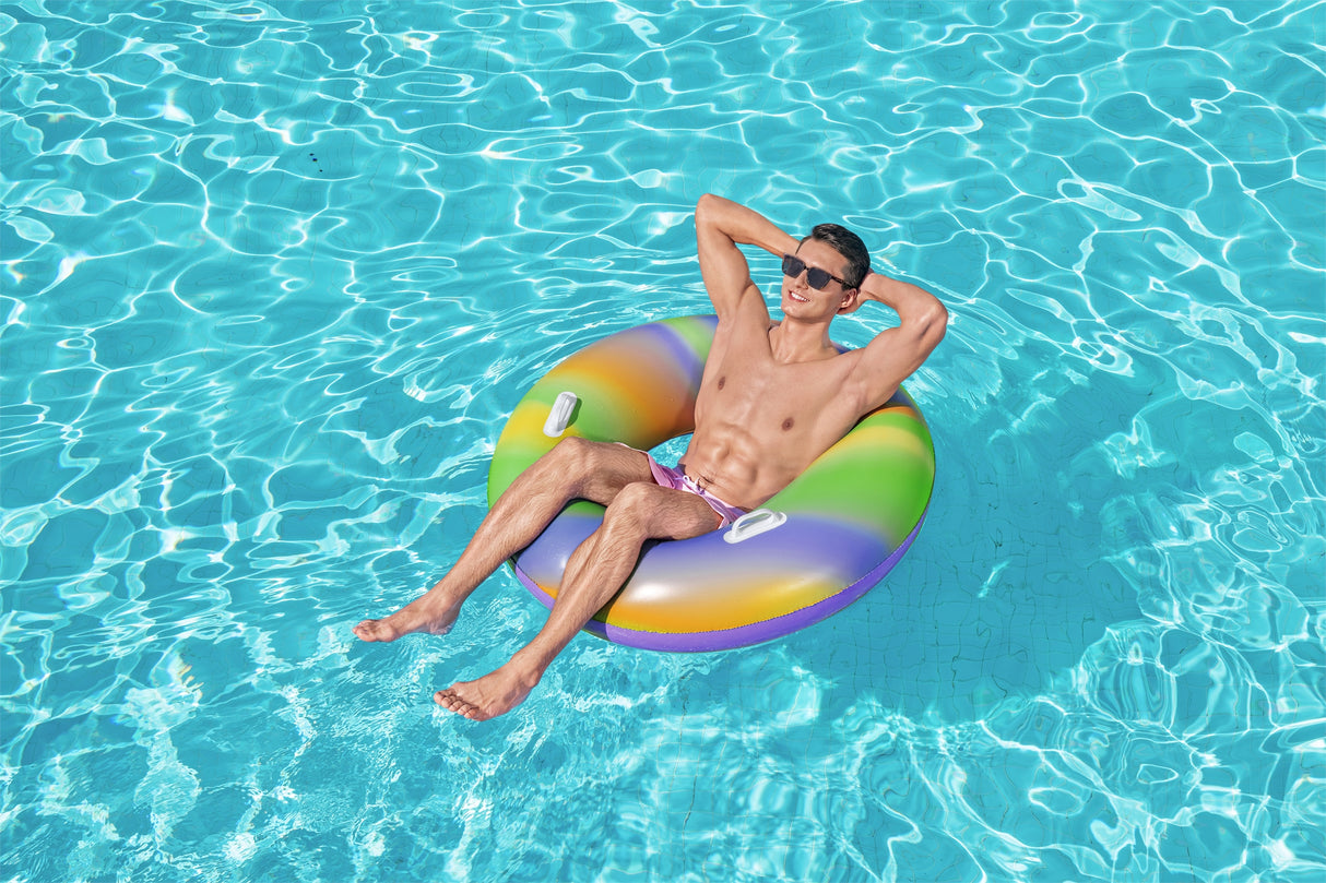 This is a lifestyle image showing a man sitting inside the inner tube with his arms behind his head.