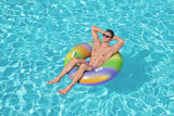 This is a lifestyle image showing a man sitting inside the inner tube with his arms behind his head.