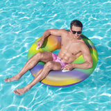 This is a lifestyle image showing a man sitting inside the inner tube in a pool.