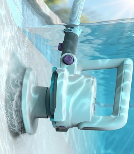 This is a lifestyle image showing the electric scrubber in use on the side of a pool.