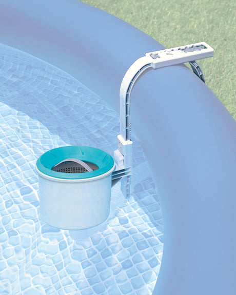 This is a lifestyle image showing the automatic surface skimmer mounted on the inflatable wall of an Intex pool.