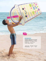 This is a lifestyle image showing a man pretending to drink this boba pool float on the beach.