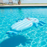 This is a lifestyle image showing the axolotl pool inflatable floating on the surface of a pool.