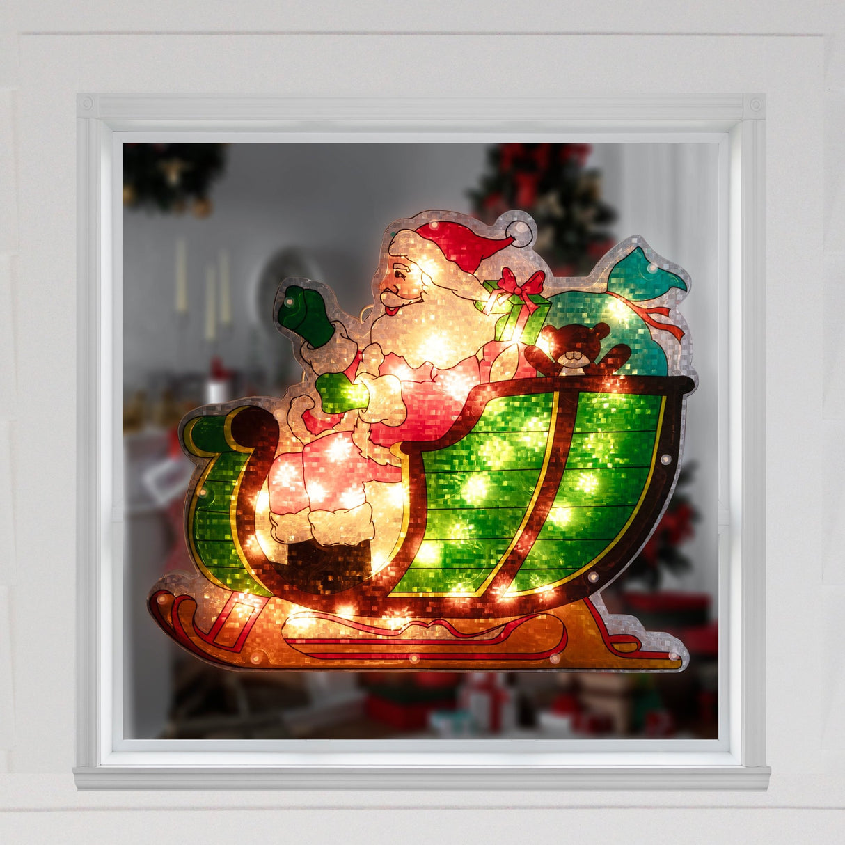 This is a lifestyle image showing this Santa Claus decoration hanging in a window.
