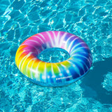 This image shows the tie dye inner tube floating on the surface of a pool.