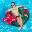 This is a lifestyle image showing a woman resting inside the inner tube in a pool.