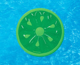 This is a lifestyle image showing the lime slice float in a pool. The outside of the float is a light green color, the inside of the float is a transparent green color and the pit/seeds inside are the light green color.