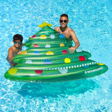 This is a lifestyle image showing a young boy and his dad holding the Christmas tree float in a pool.