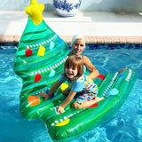 This is a lifestyle image showing a young child playing on the tree float in a pool while their Grandma looks on.