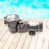This is a lifestyle image showing the pump on a deck next to a pool.