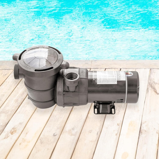 This is a lifestyle image showing the pump on a deck next to a pool.