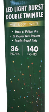 This image shows the packaging that this LED light burst double twinkle decoration comes in. It reads "Multi & Cool White. Indoor or Outdoor use. 28 wrapped wire branches. Includes ground stake. 36 inches. 140 lights."