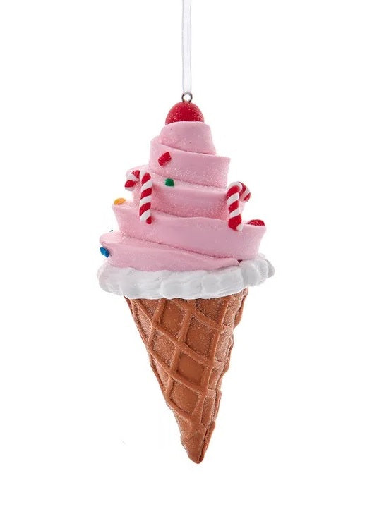 This ornament is designed to look like an ice cream cone with pink ice cream on a brown one. There's a cherry on top, multi-colored sprinkles and some small candy canes.
