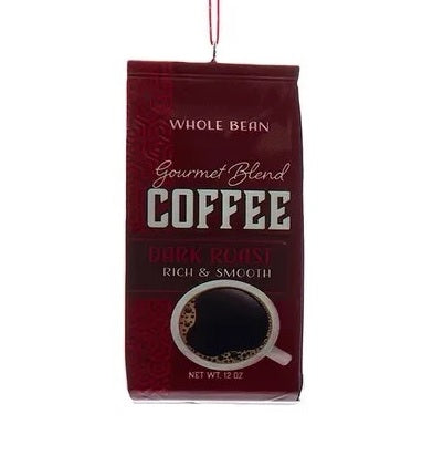 This ornament is designed to look like a bag of coffee that is maroon and reads "Whole Bean Gourmet Blend Coffee Dark Roast Rich & Smooth."