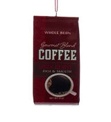 This ornament is designed to look like a bag of coffee that is maroon and reads "Whole Bean Gourmet Blend Coffee Dark Roast Rich & Smooth."
