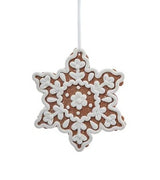 This image shows the ornament shaped like a gingerbread snowflake. It has swirly white "frosting" accents in the center.