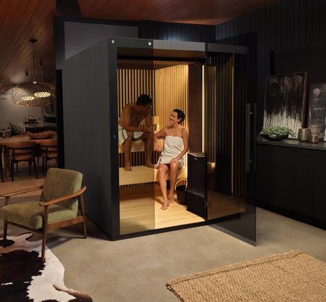 This image shows two people inside their sauna with the door open.